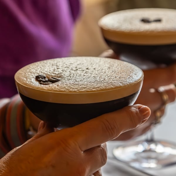 Espresso martini cocktails being held at a party