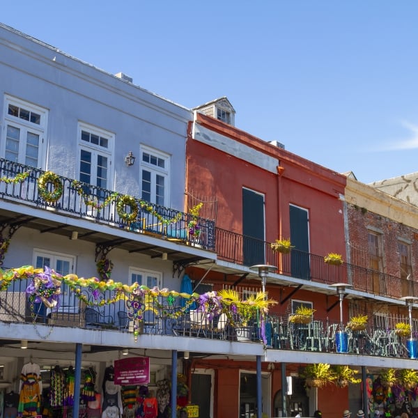 New Orleans, Louisiana in Mardi Gras Carnival Celebrations. Balconies of colorful buildings decorated with Mardi Gras beads and festive decorations in the French Quarter of New Orleans, Louisiana, a popular travel destination