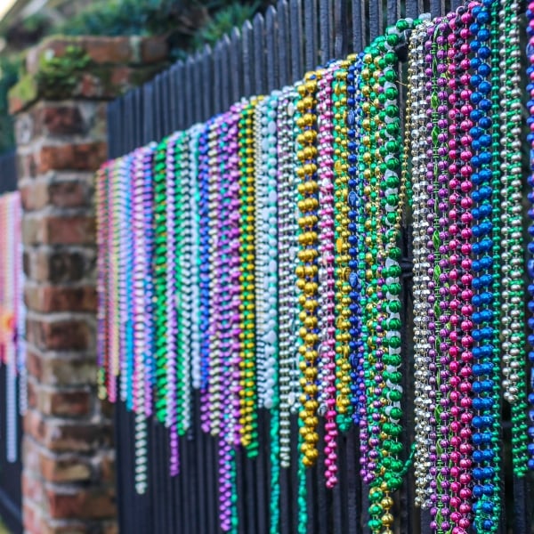 During Mardi Gras, the whole city of New Orleans gets covered in colorful plastic beads, even hanging from fences and along peoples homes. Colorful and unexpected