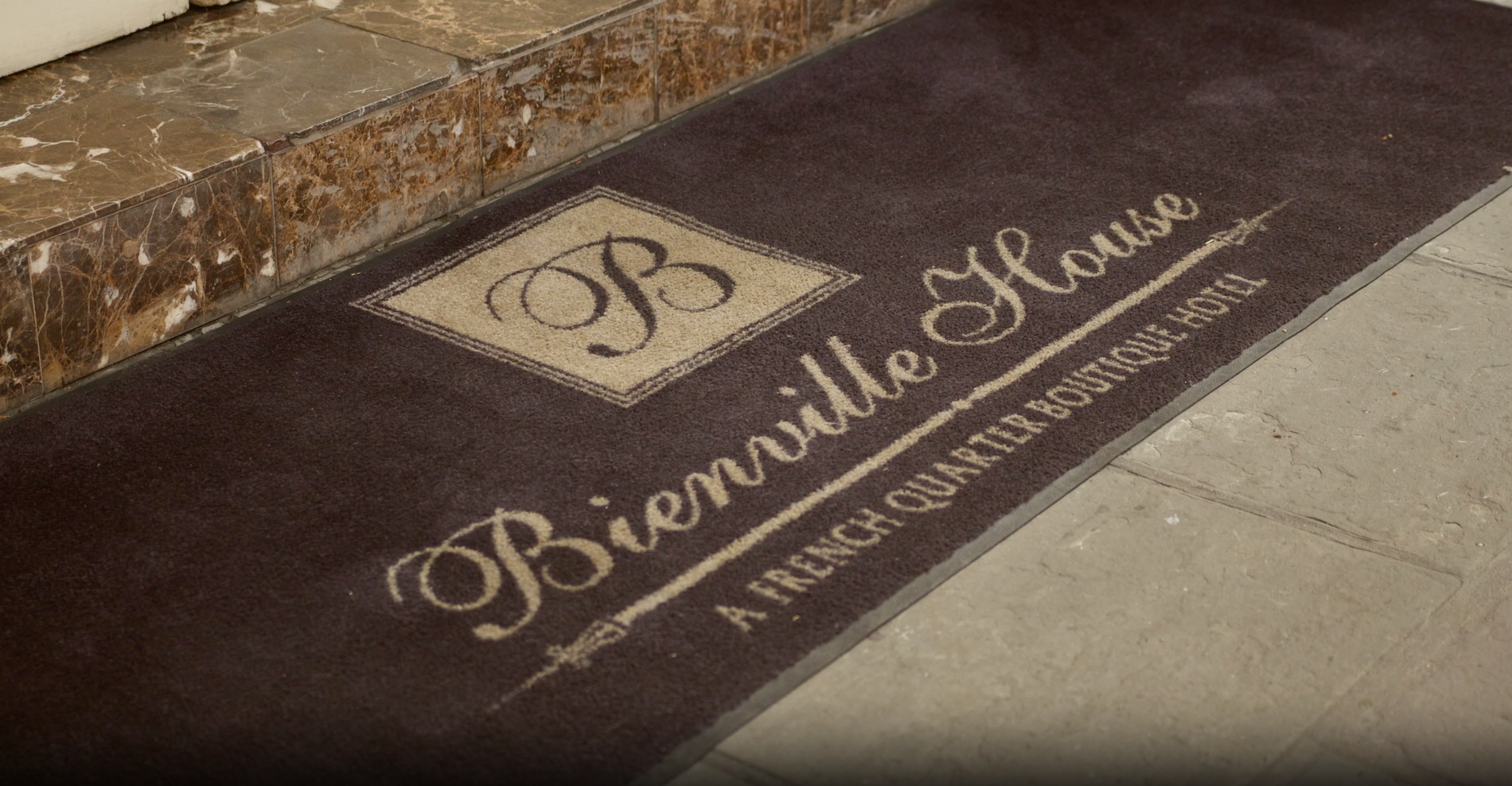 A doormat with the Bienville House logo and text: 
