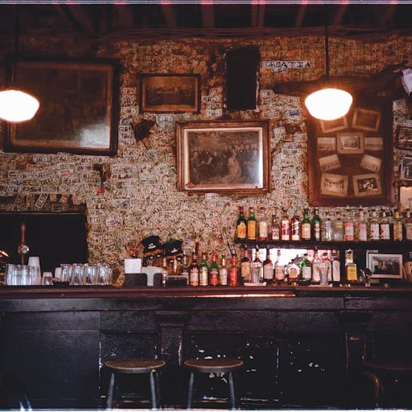 Signed dollar bills paper the back wall of this ancient bar in New Orleans