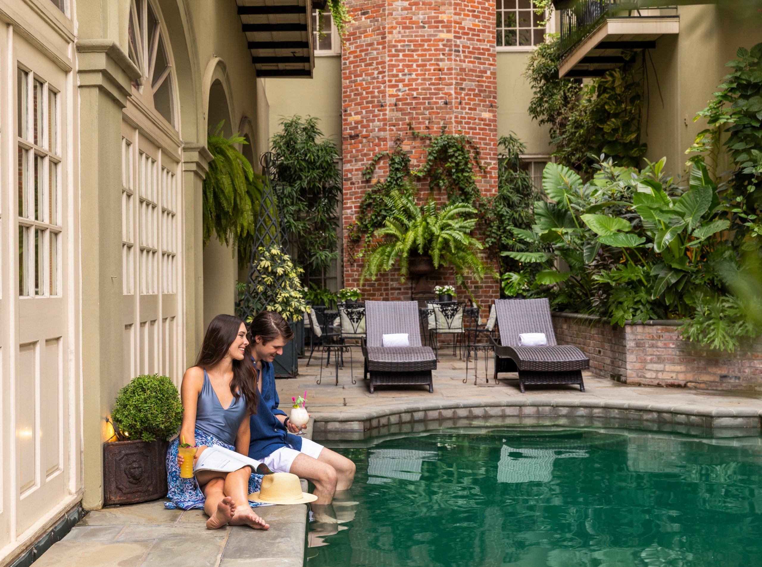 couple sitting by the courtyard pool